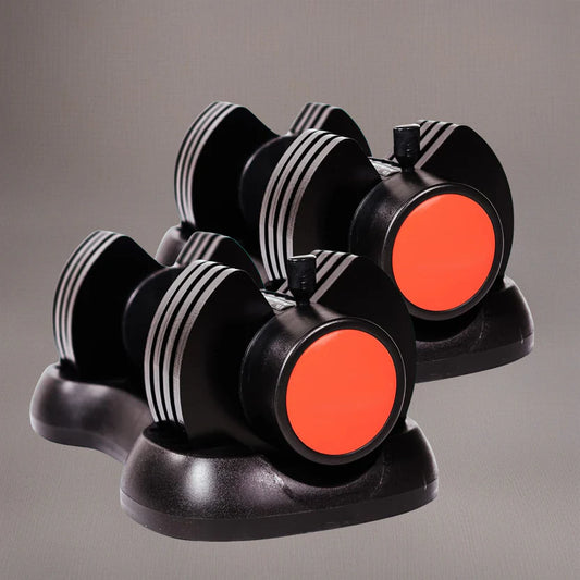 Black and orange dumbbell set on a gray background