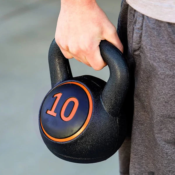 Three kettlebells with weights on a wooden floor
