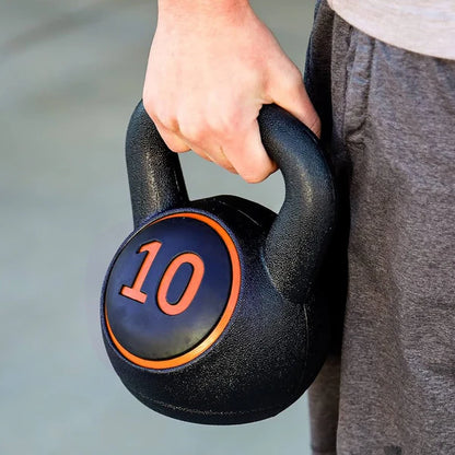 Three kettlebells with weights on a wooden floor