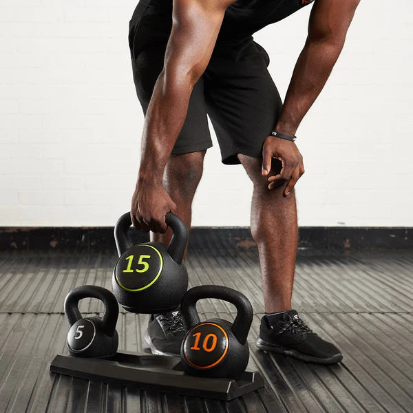 Three kettlebells with weights on a wooden floor