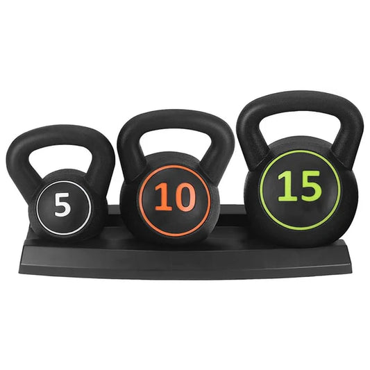 Three kettlebells with weights on a wooden floor